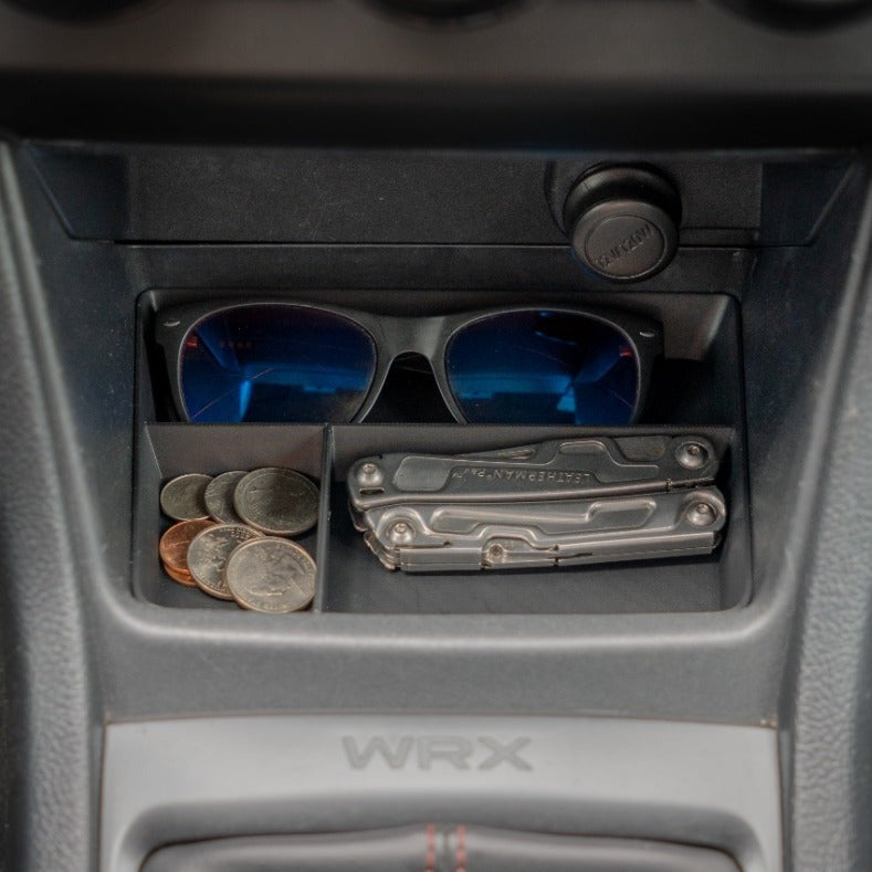 Custom-designed VOXELWERKZ center console organizer in a Subaru WRX, efficiently storing sunglasses and change, tailored for 2015-2021 manual models.